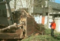 Rachel Corrie stands in front of a bulldozer in Palestine